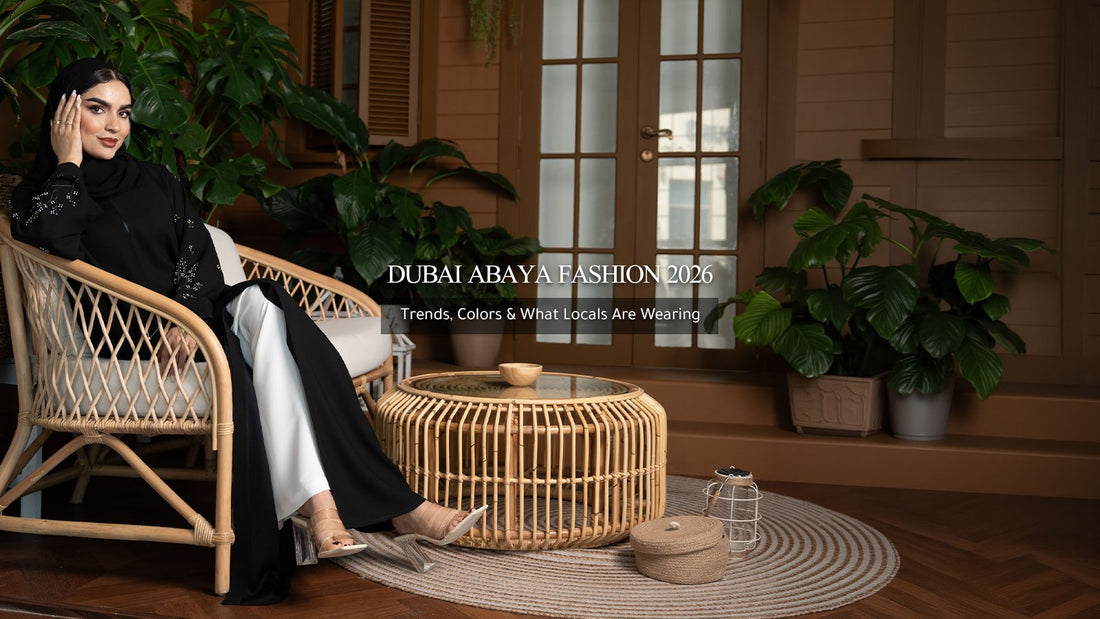 Dubai abaya fashion 2026: woman in a black embellished abaya seated in a rattan chair